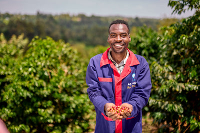 Coffee farmers holding cherries